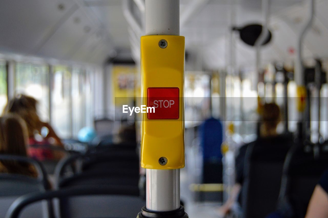 Close-up of push button with stop text in bus