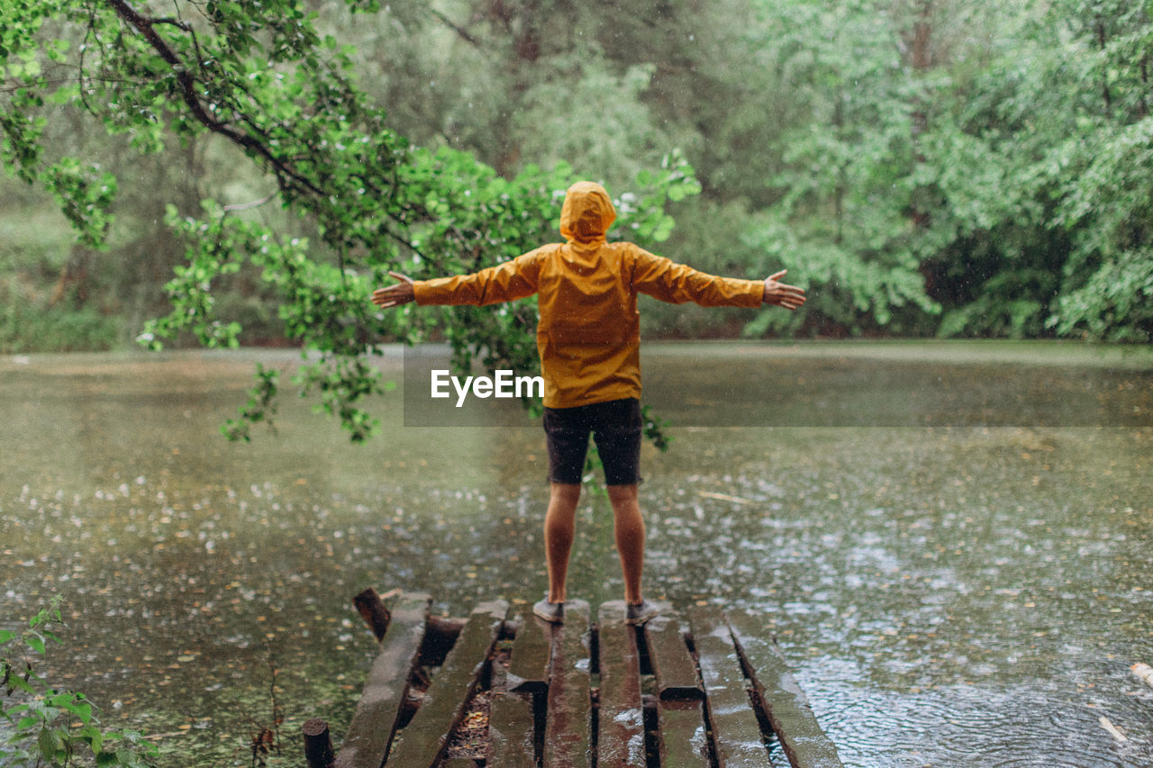 FULL LENGTH OF BOY STANDING ON WATER