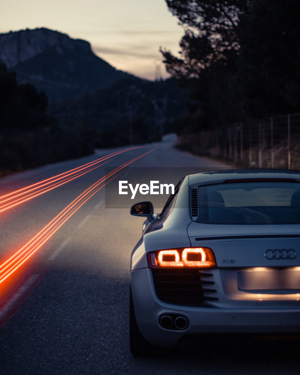 CARS ON ROAD AT DUSK