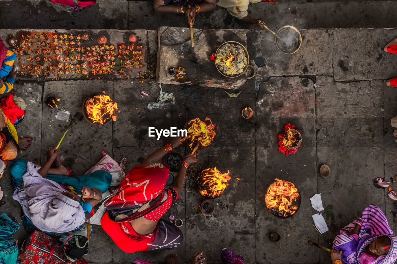 Ariel shot of women performing rituals on a bank of river ganges in a traditional way.
