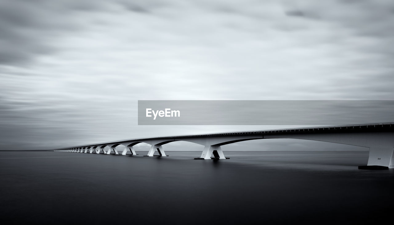 Bridge over sea against sky