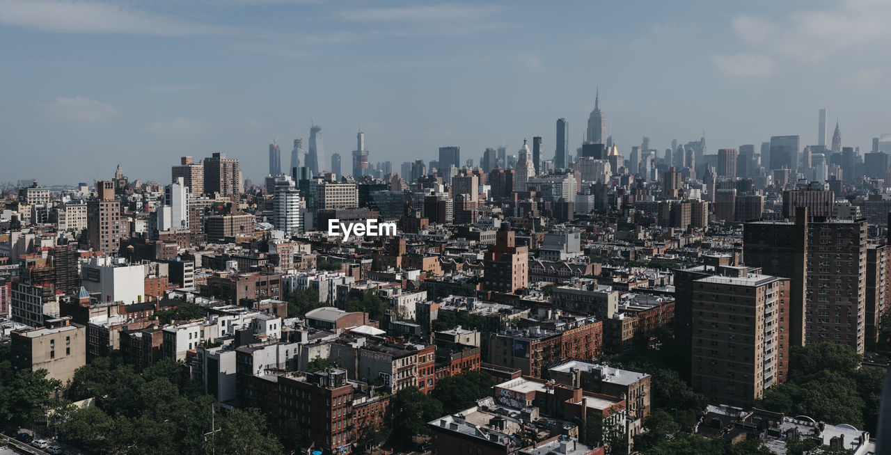 Aerial view of modern buildings in city against sky