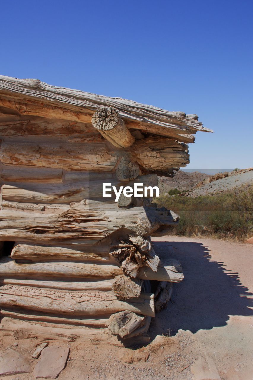 STACK OF FIREWOOD AGAINST CLEAR SKY