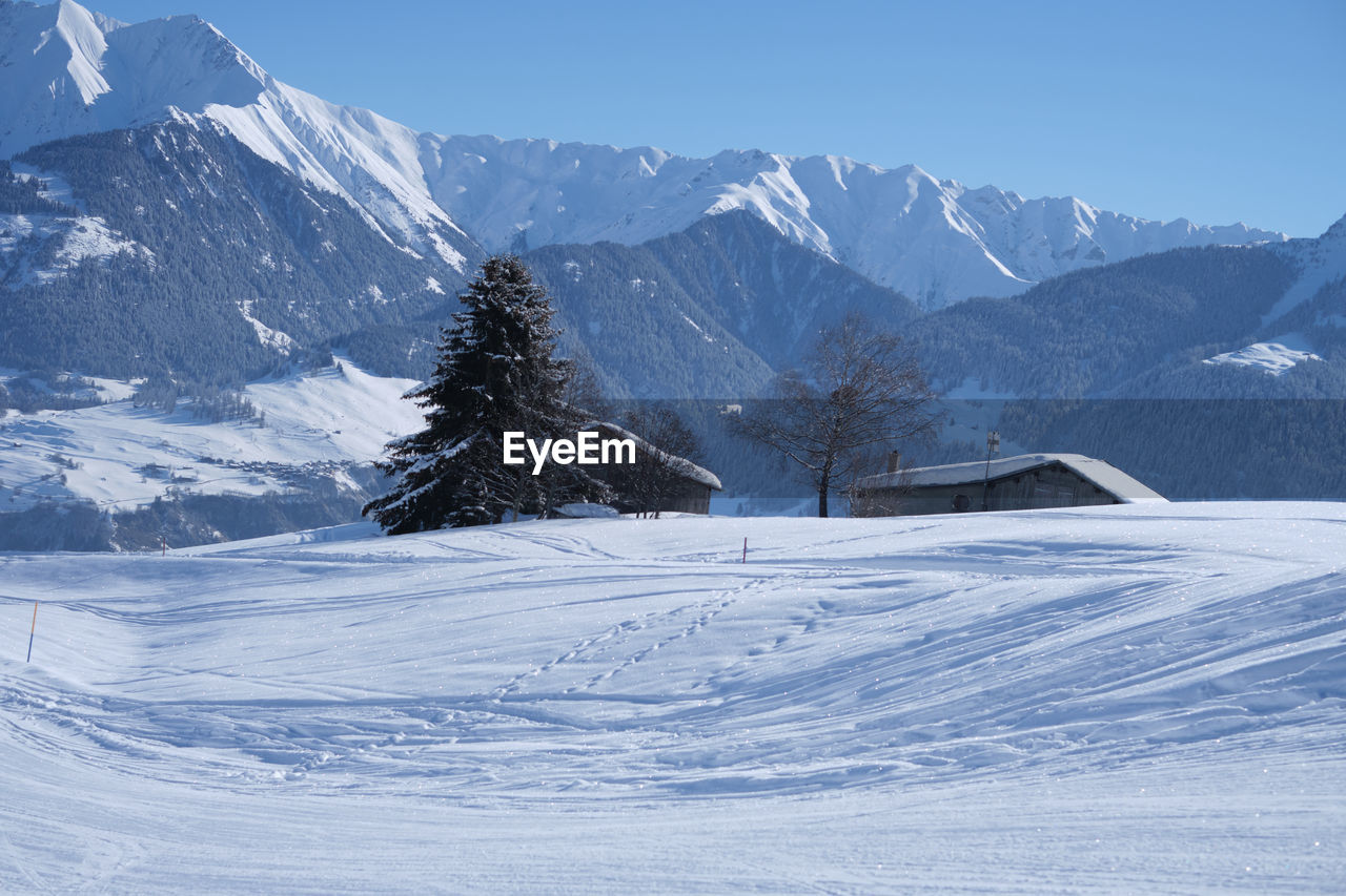 Scenic view of snow covered mountains against sky