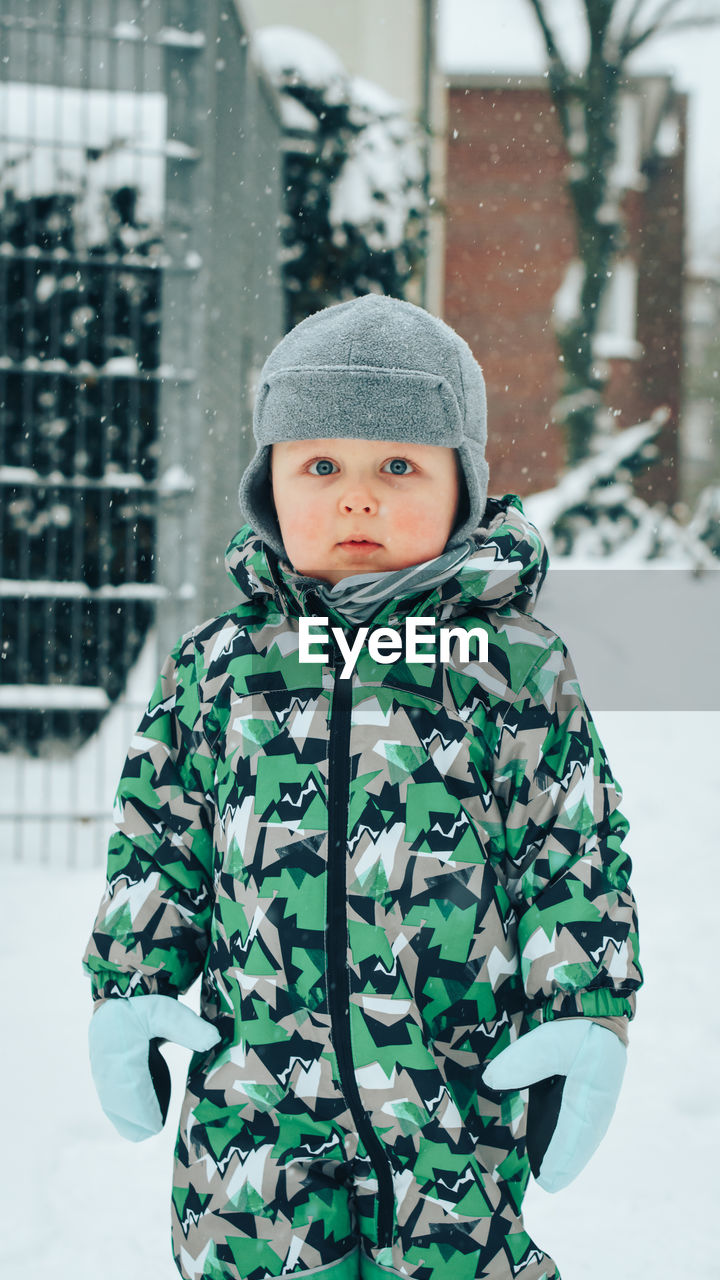 Portrait of boy standing in snow