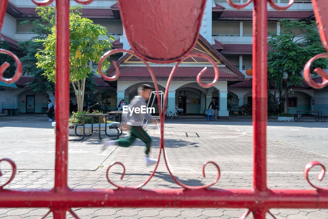 FULL LENGTH OF MAN WITH BICYCLE ON BUILDING