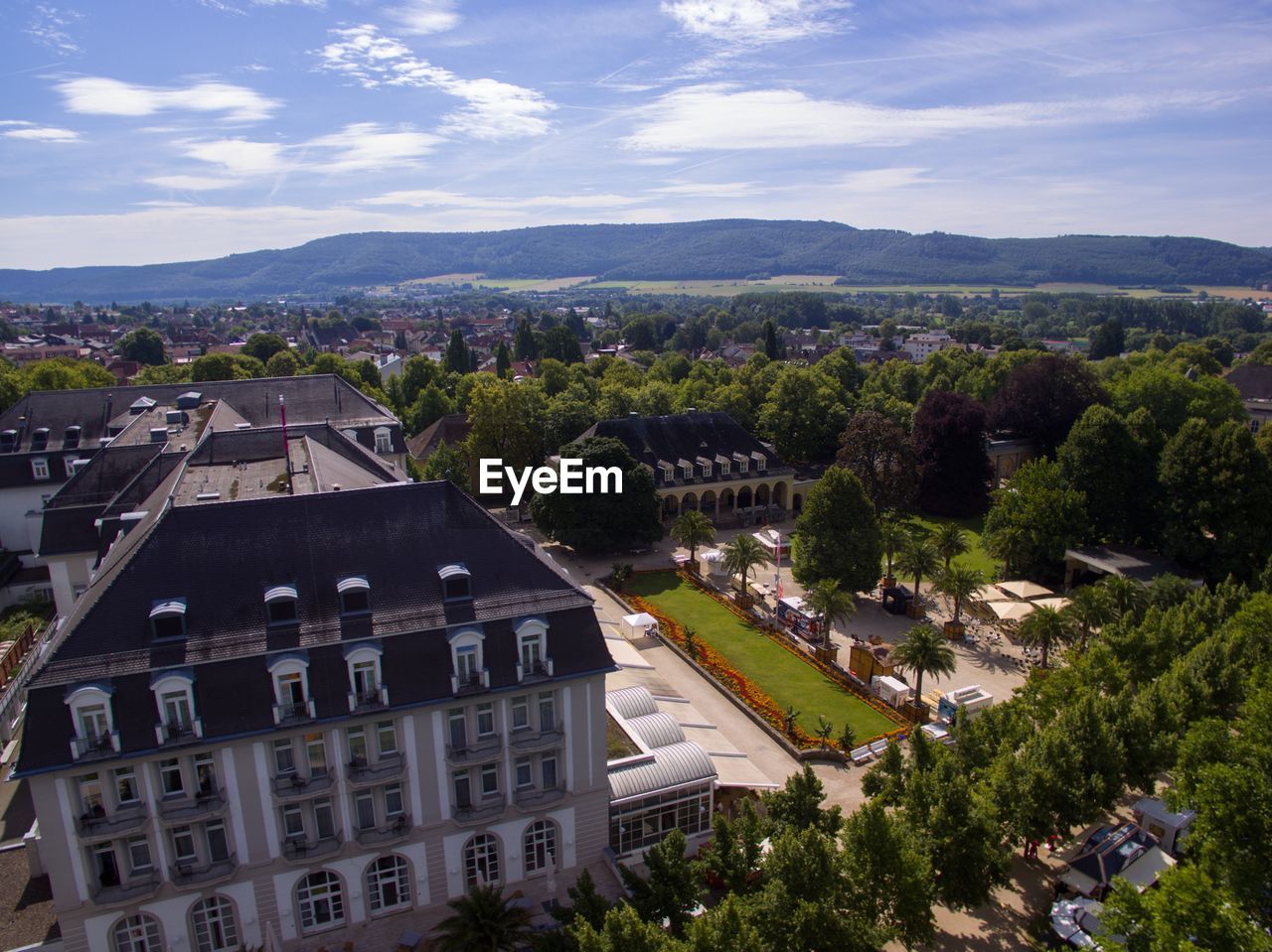 HIGH ANGLE VIEW OF HOUSES AND TREES AGAINST SKY