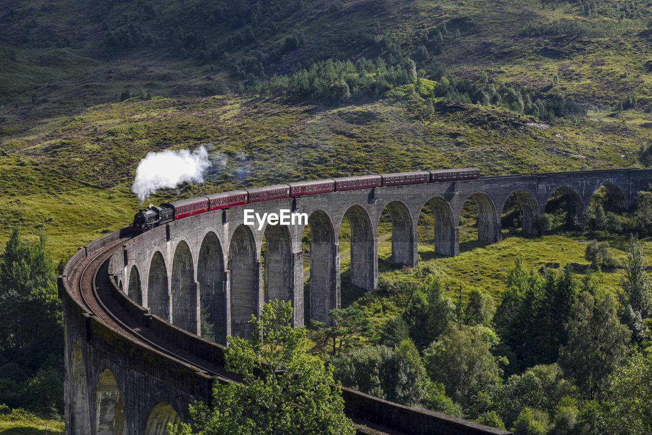 View of steam train on bridge