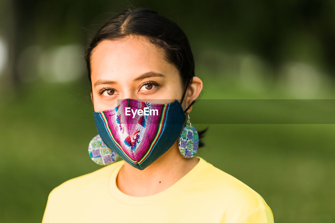 Portrait of beautiful young woman covering face