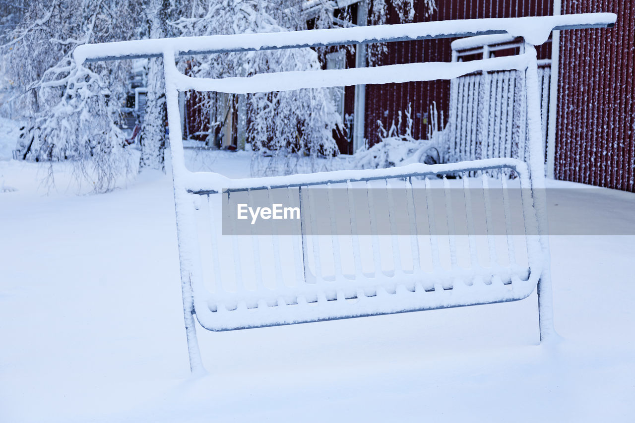 SNOW COVERED FIELD AND RAILING