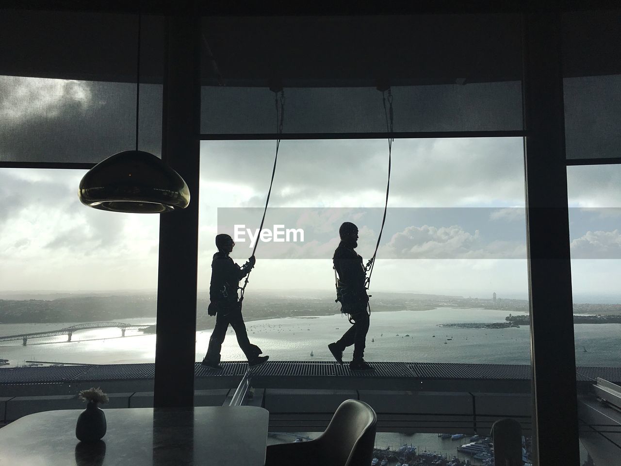 People walking on built structure by sea