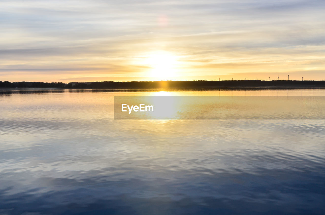 SCENIC VIEW OF SUNSET OVER SEA