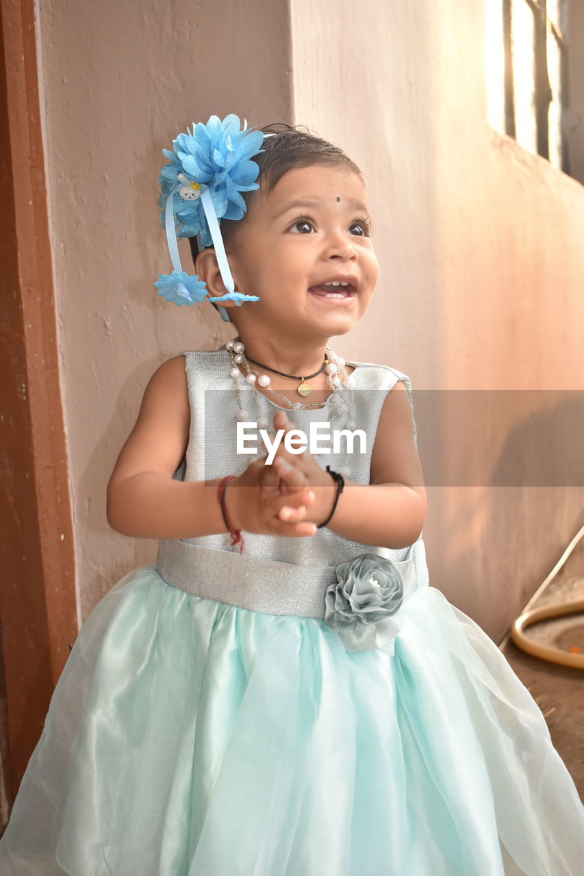 Portrait of cute girl holding happy while standing outdoors