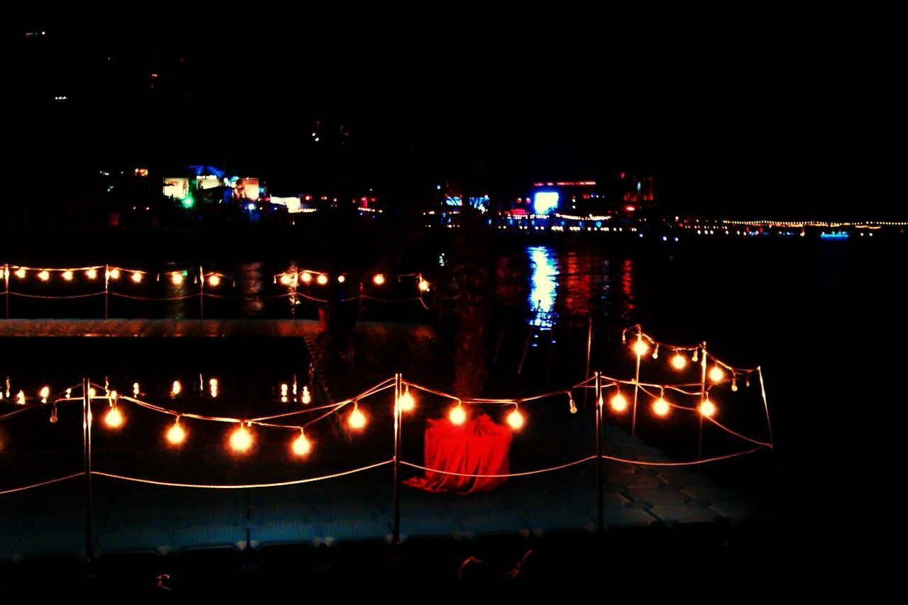 High angle view of illuminated dock by seashore