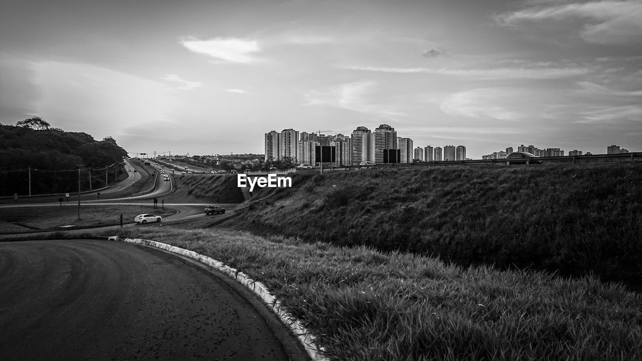 Road amidst buildings against sky in city