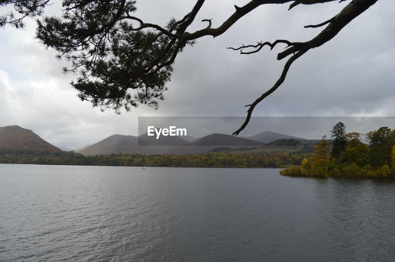 Idyllic shot of river and mountains against cloudy sky