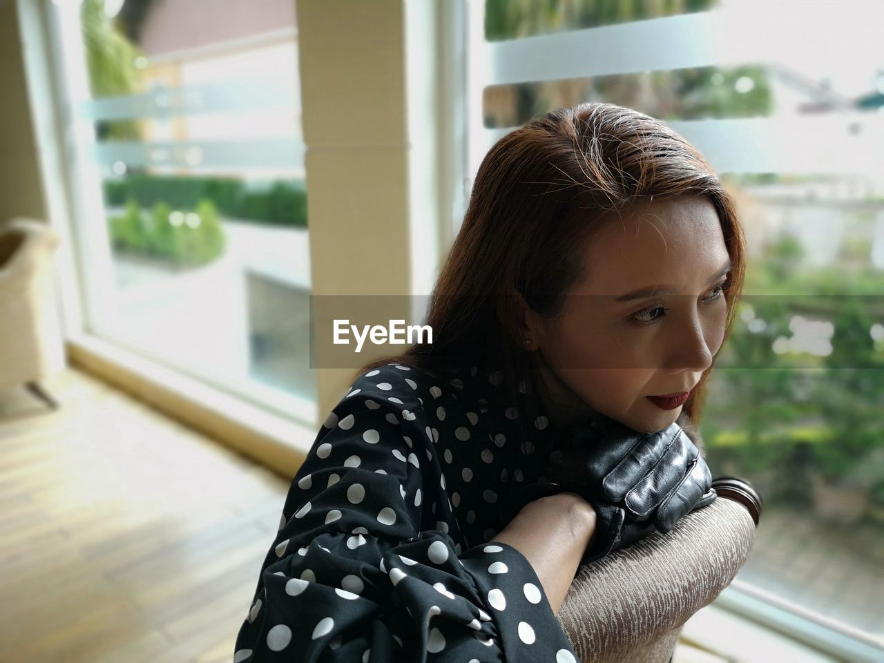 Woman looking away by window