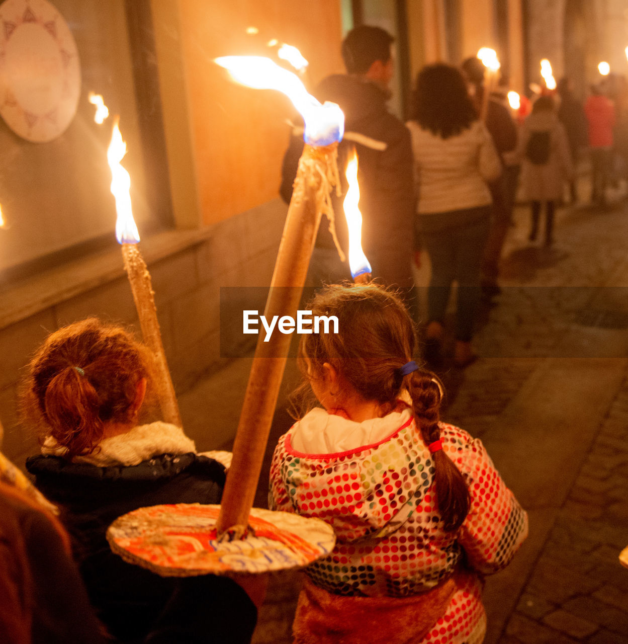 adult, women, group of people, men, child, illuminated, childhood, lighting equipment, food, female, burning, candle, food and drink, lifestyles, night, celebration, holding, architecture, fire, nature, togetherness, temple, sitting