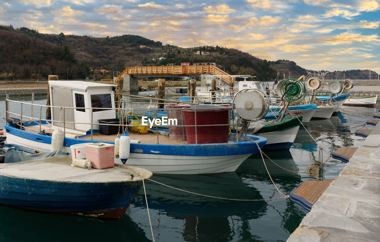 Moored fishing boats at sunset near strunjan, slovenia