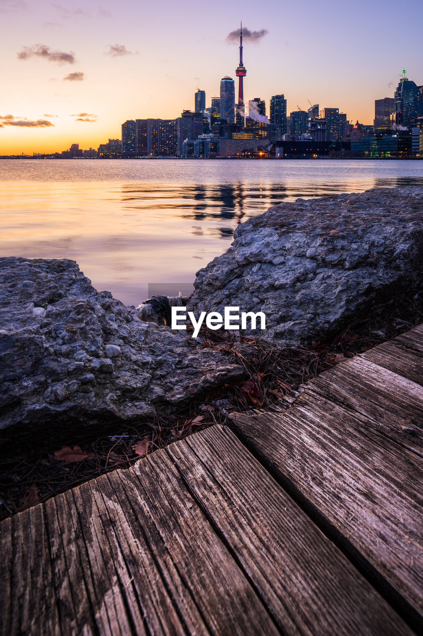 View of buildings in city at sunset