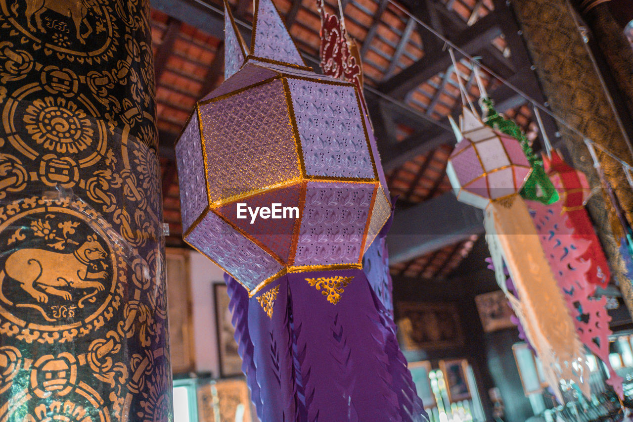 LOW ANGLE VIEW OF DECORATIONS ON CEILING OF BUILDING