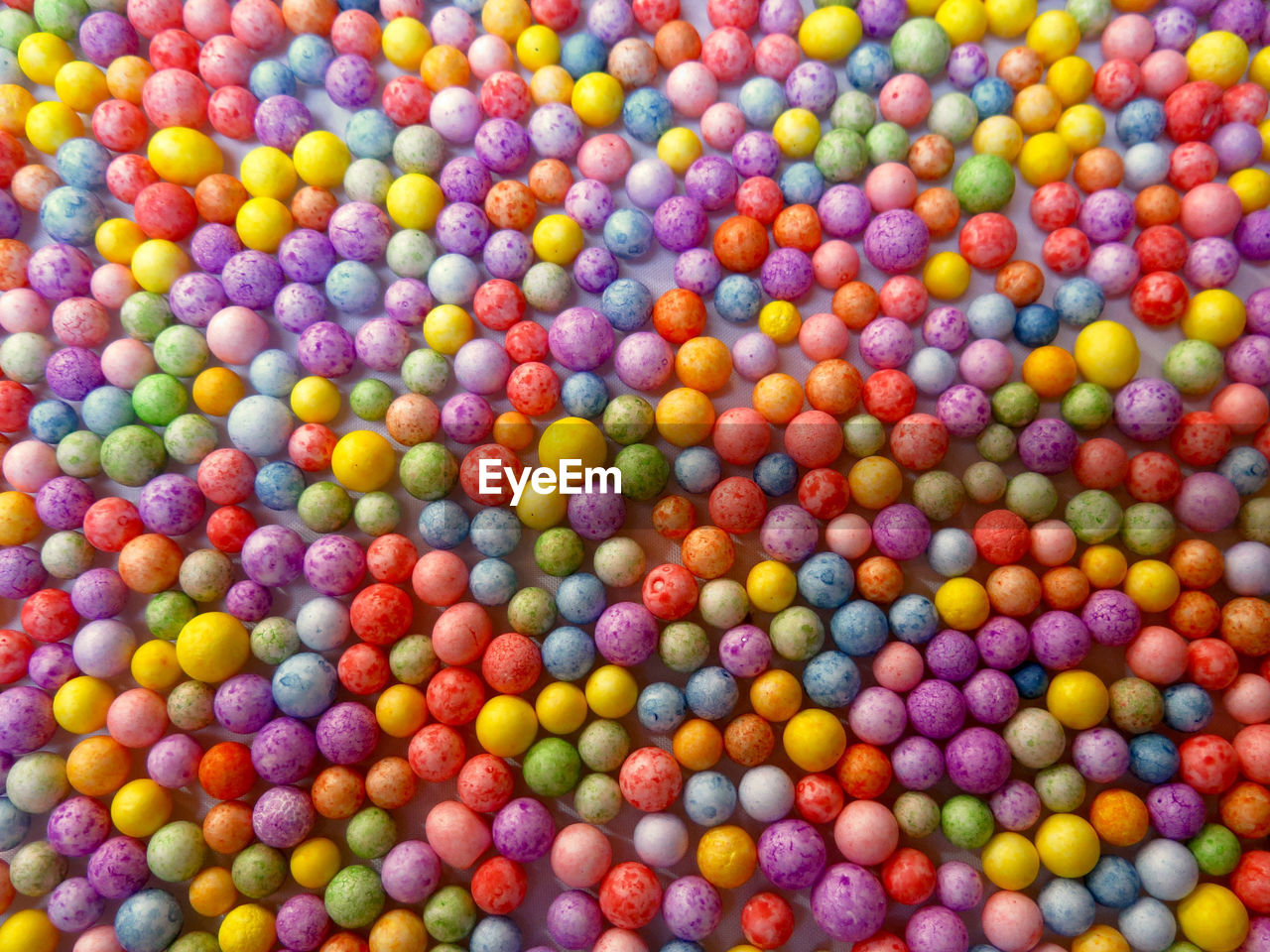 Directly above colorful polystyrene balls on table