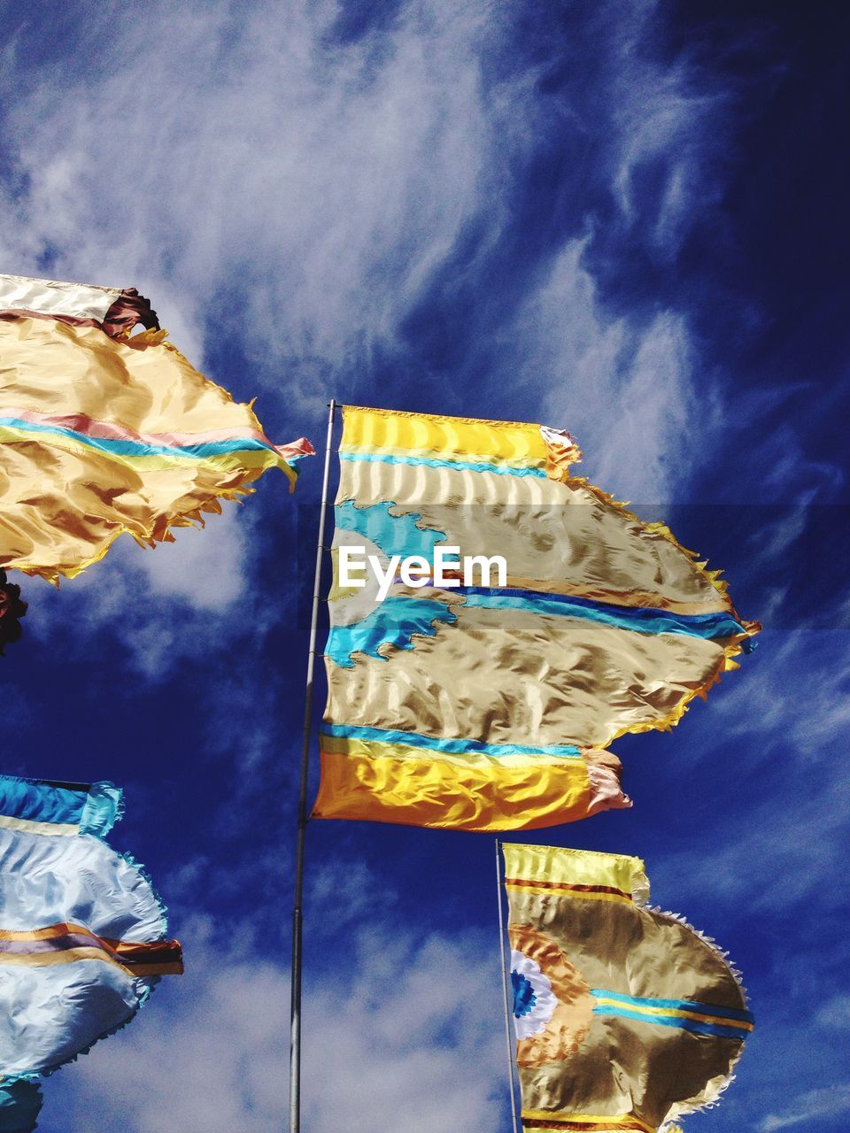 Low angle view of flags fluttering against sky