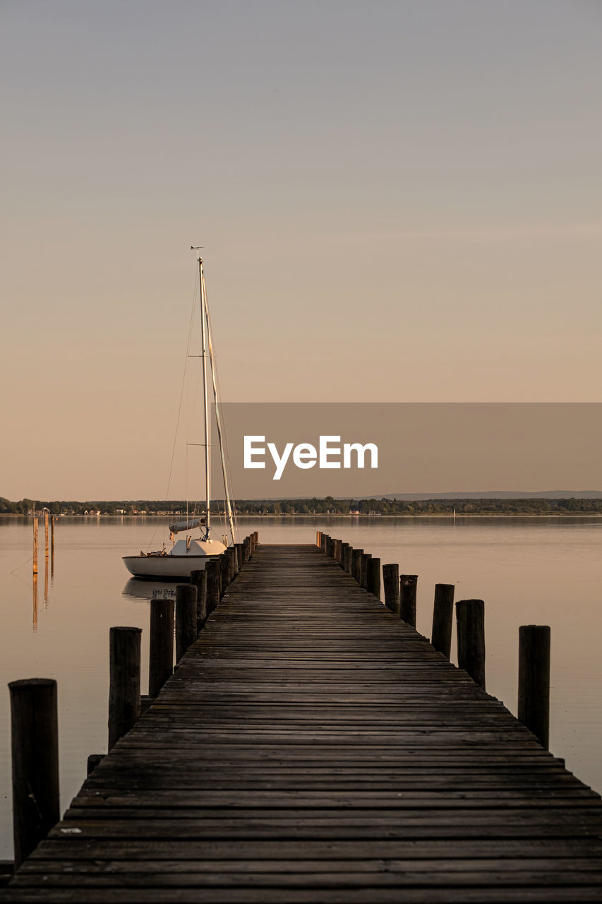 Pier over sea against clear sky