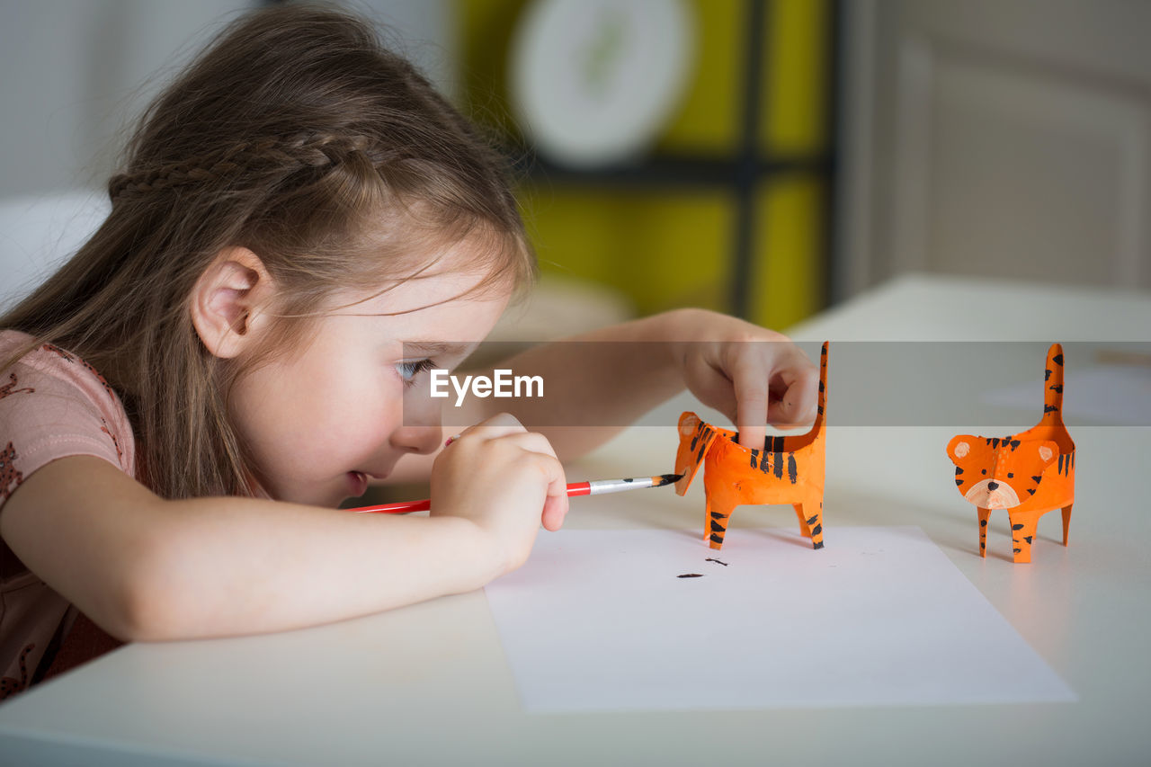 PORTRAIT OF GIRL WITH TOY