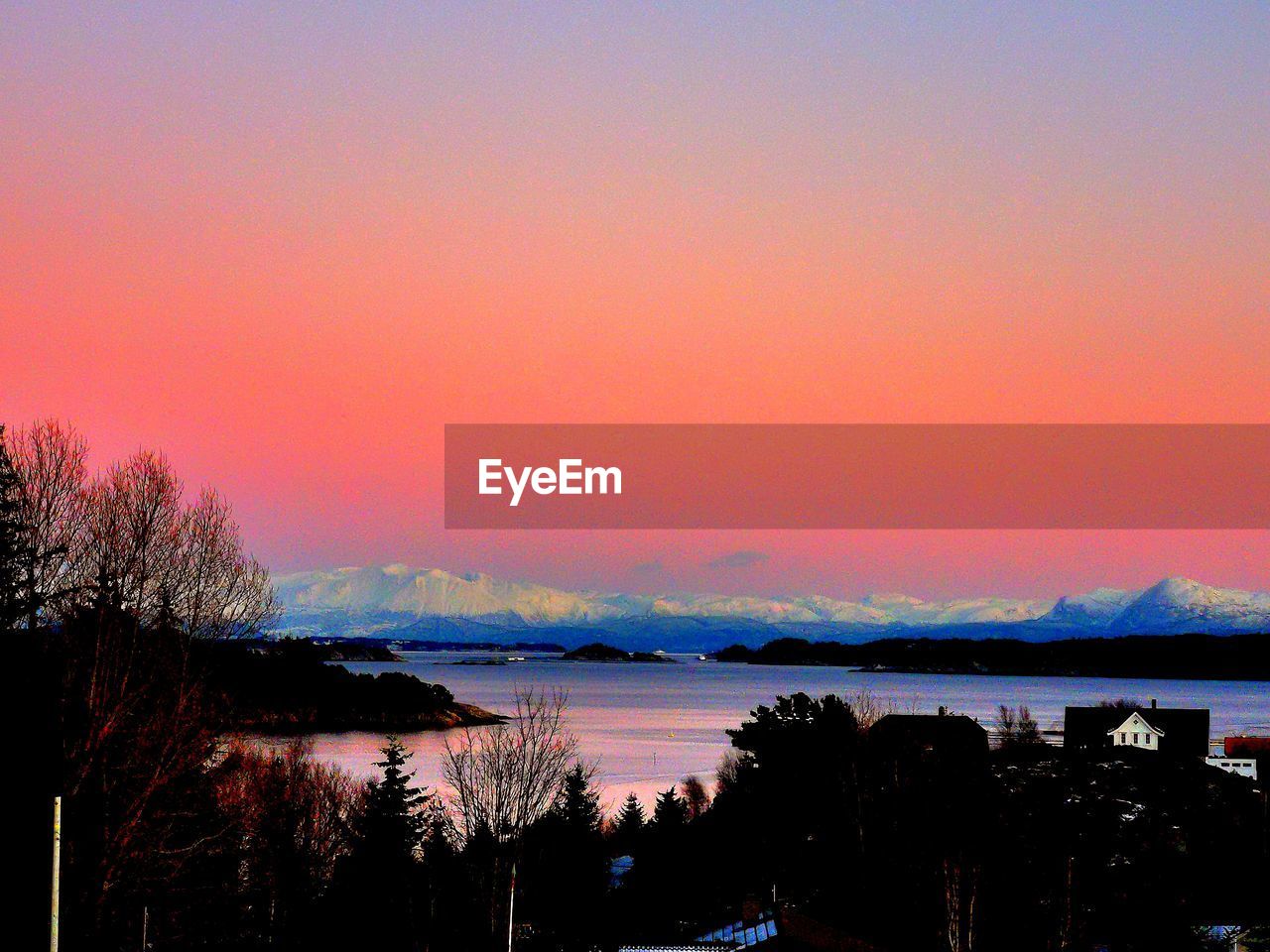 SCENIC VIEW OF LAKE AGAINST ORANGE SKY