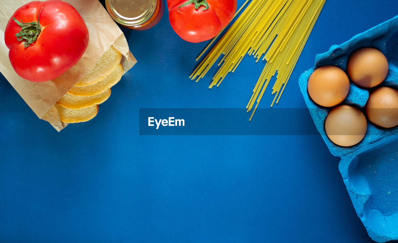 HIGH ANGLE VIEW OF TOMATOES AND BLUE TABLE