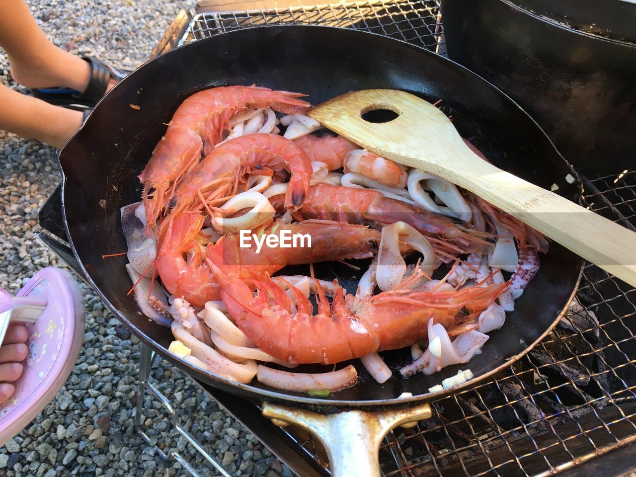 food, food and drink, seafood, freshness, kitchen utensil, high angle view, crustacean, animal, dish, shrimp, healthy eating, household equipment, meat, wellbeing, hand, cooking pan, day, one person, seafood boil