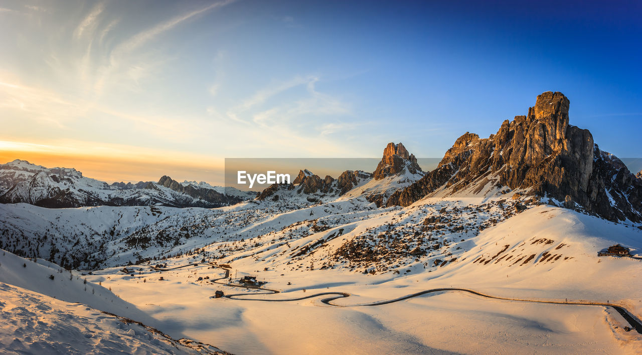 Scenic view of snowcapped mountains against sky during sunset