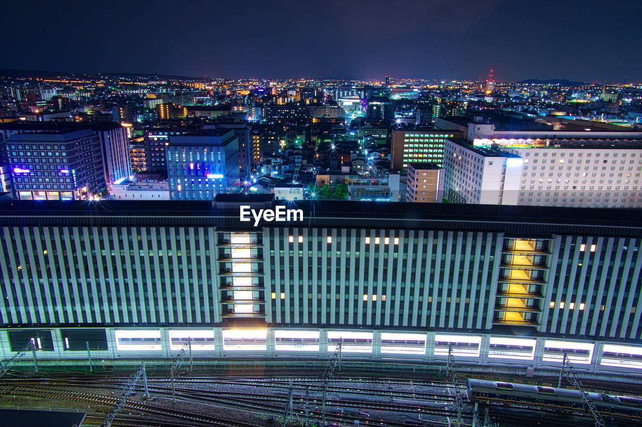 High angle view of illuminated buildings in city at night