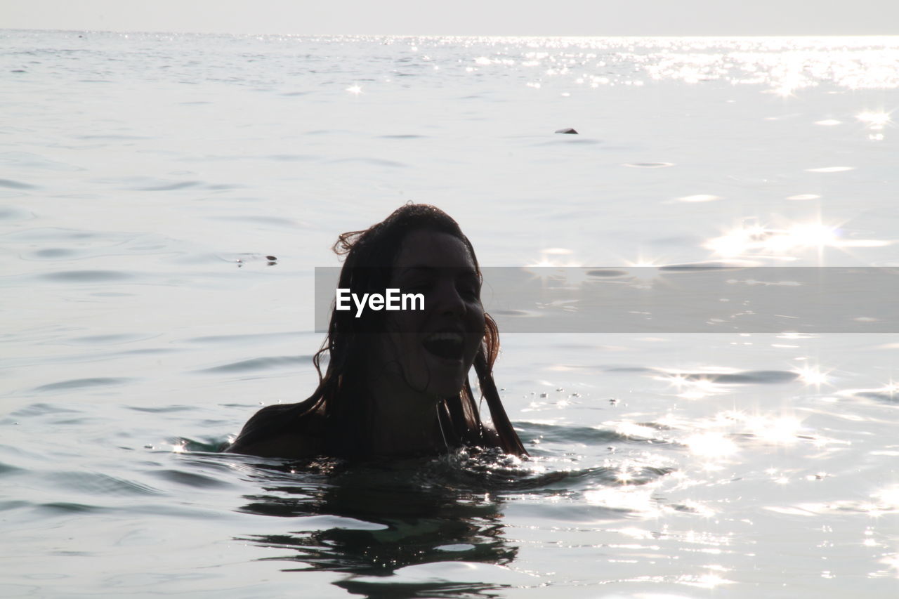 Young woman swimming in sea