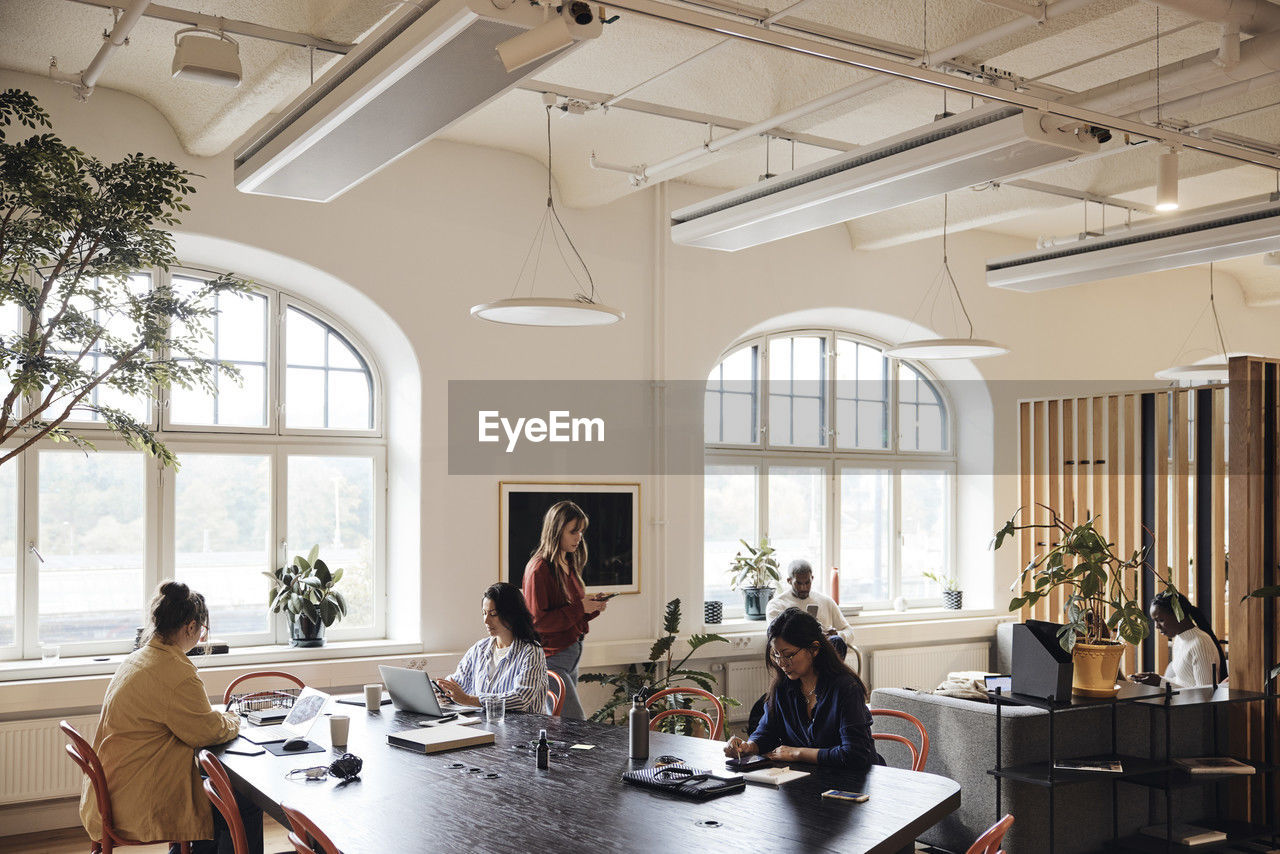 Male and female business colleagues working together at coworking office