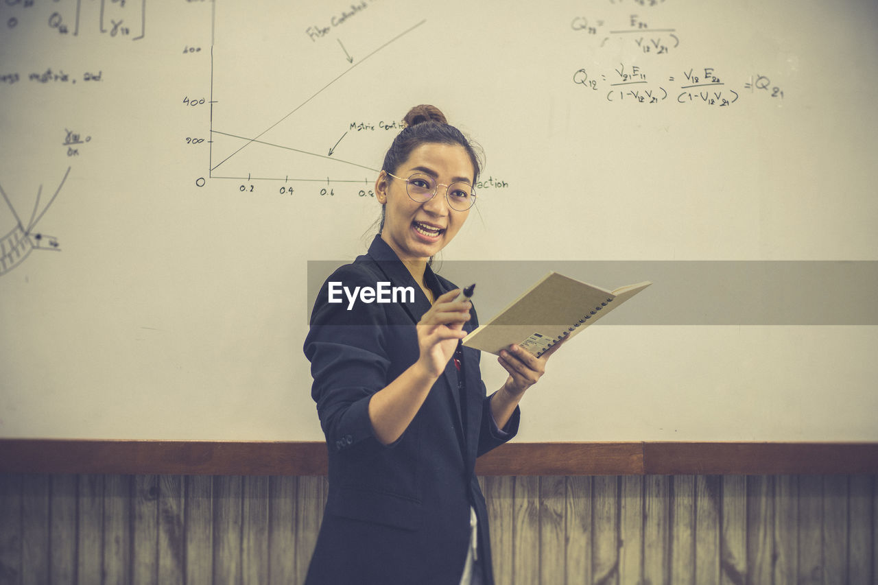 Teacher is teaching physics to students during the new school days after a long break