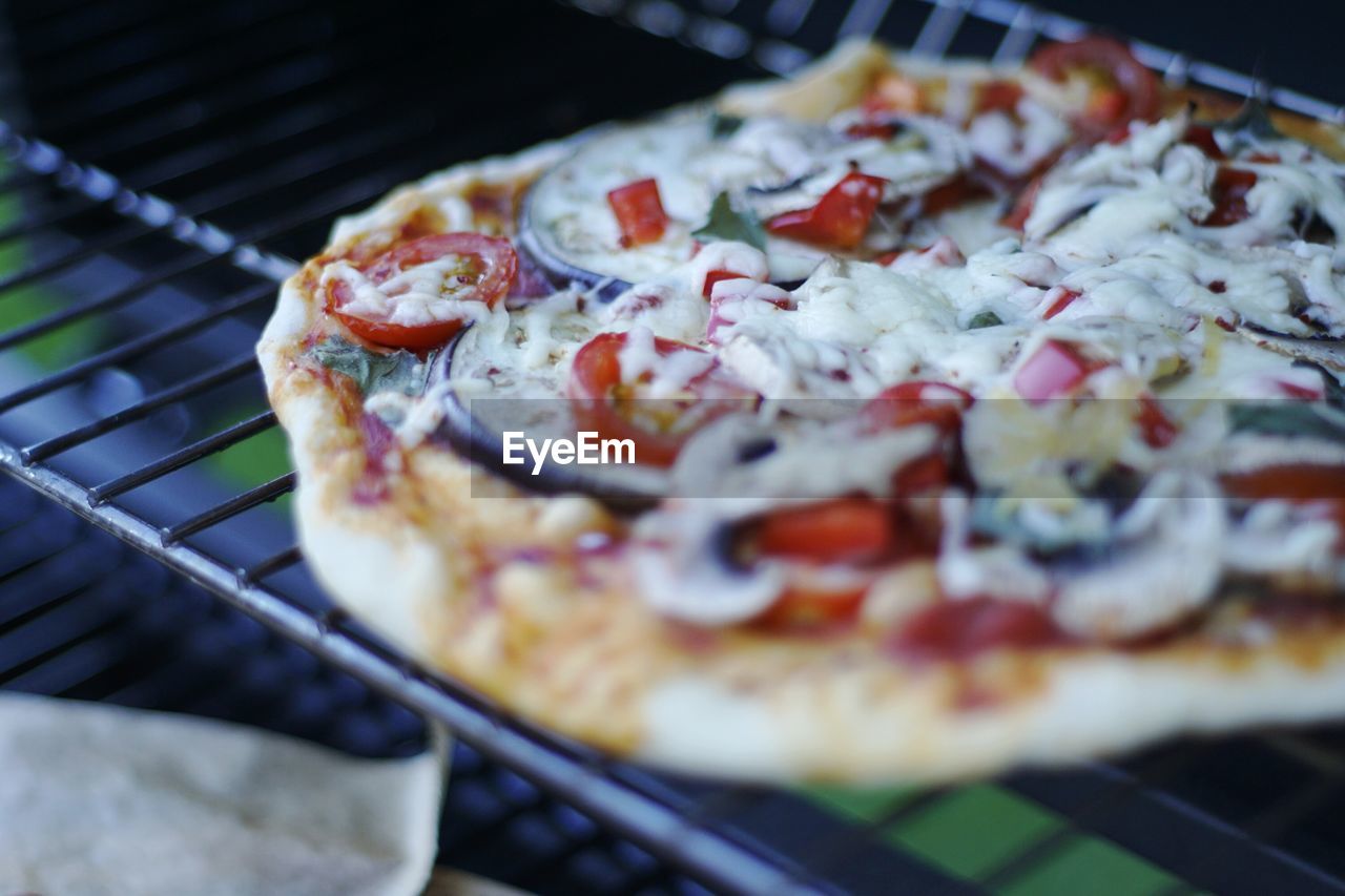 Close-up of pizza on cooling rack