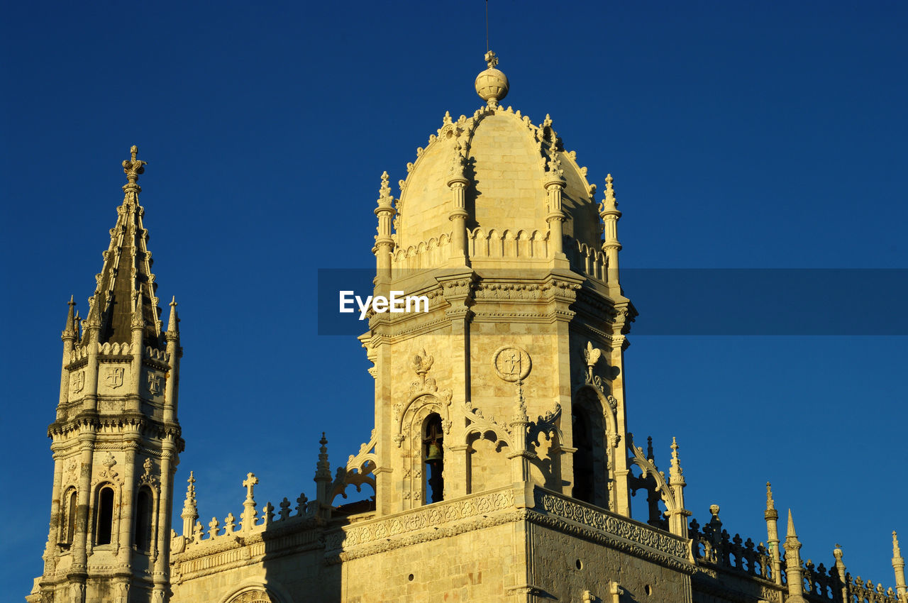 Low angle view of historical building against blue sky