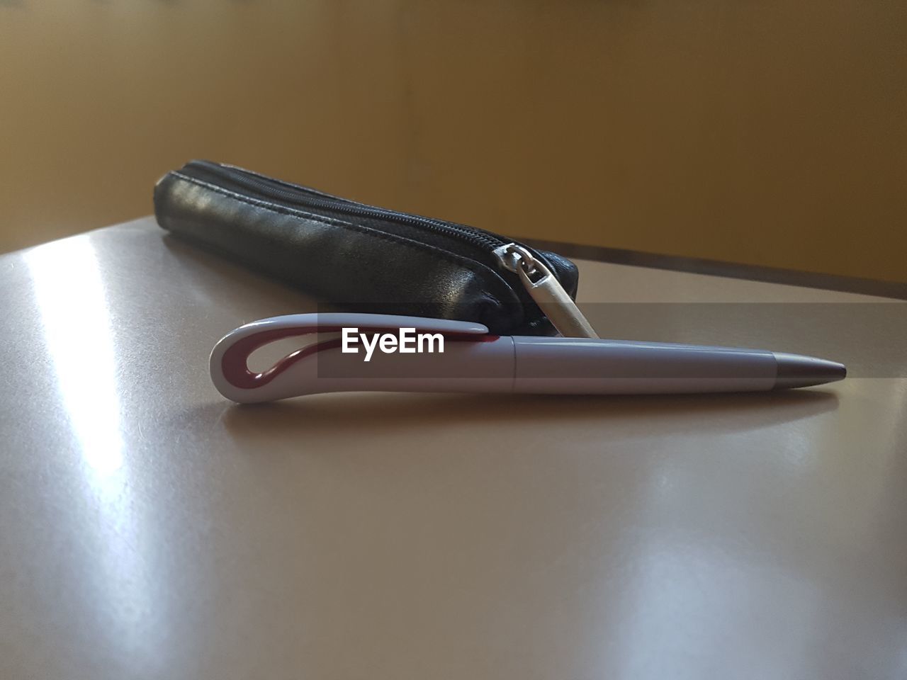 Close-up of pen and pouch on table