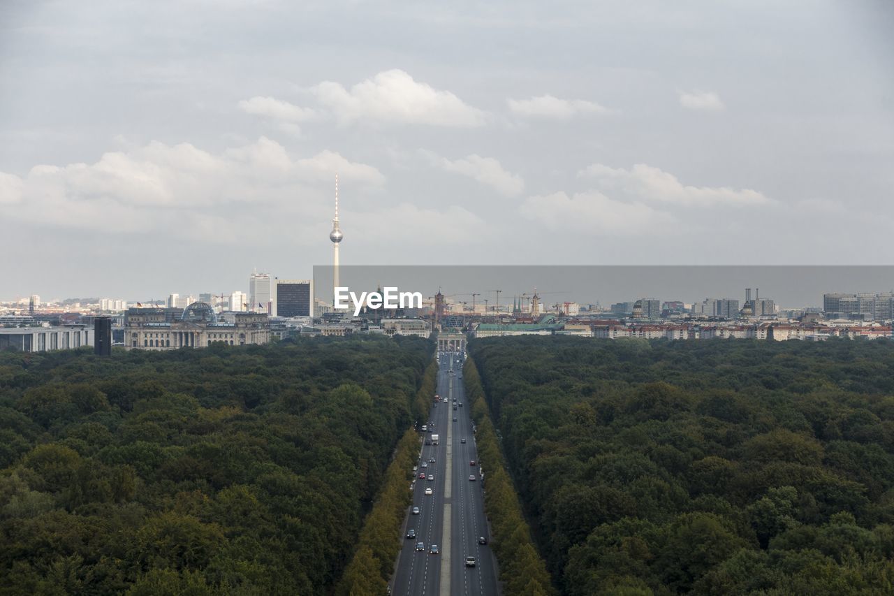 View of cityscape against cloudy sky