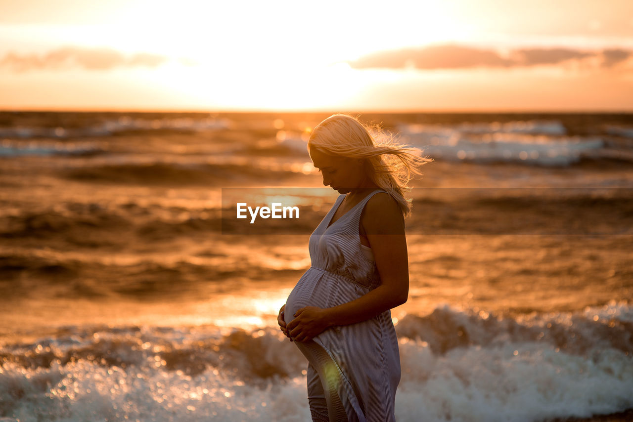 Woman on beach at sunset