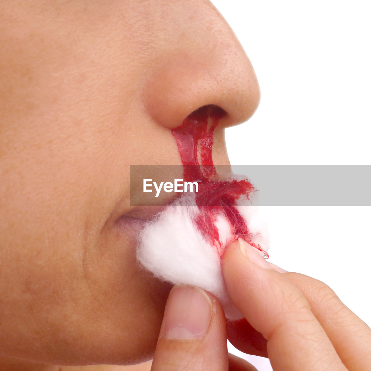 Midsection of boy with bleeding nose against white background