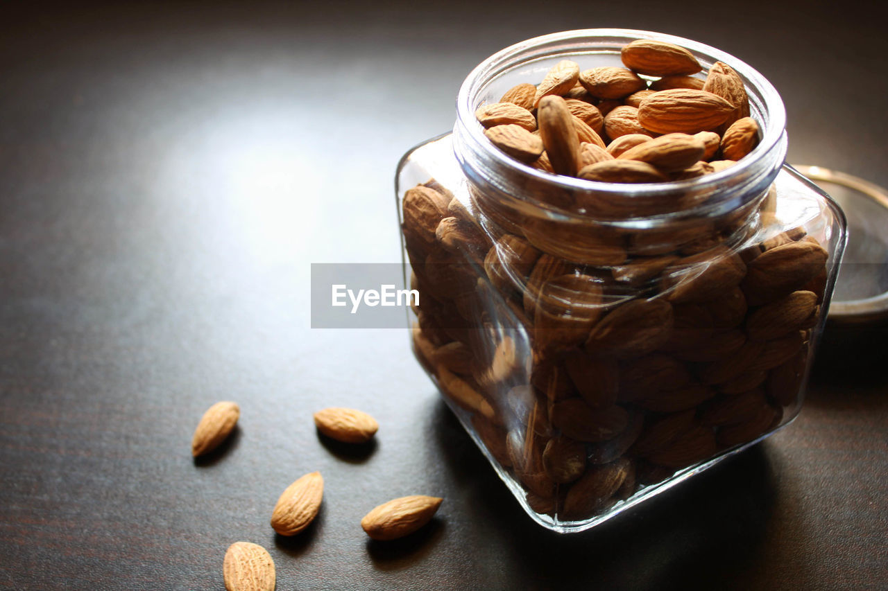 High angle view of almonds in jar on table