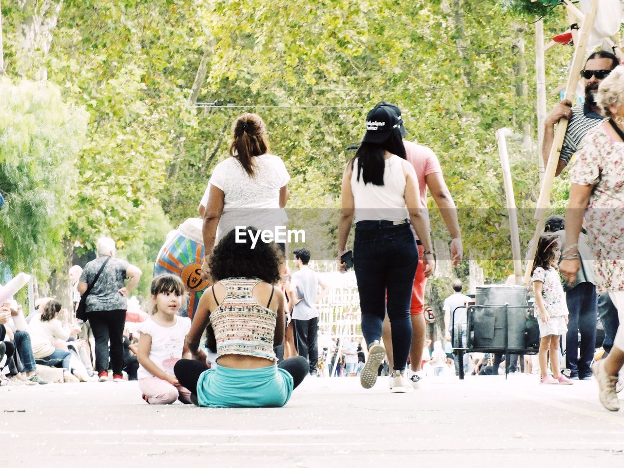 PEOPLE SITTING ON STREET