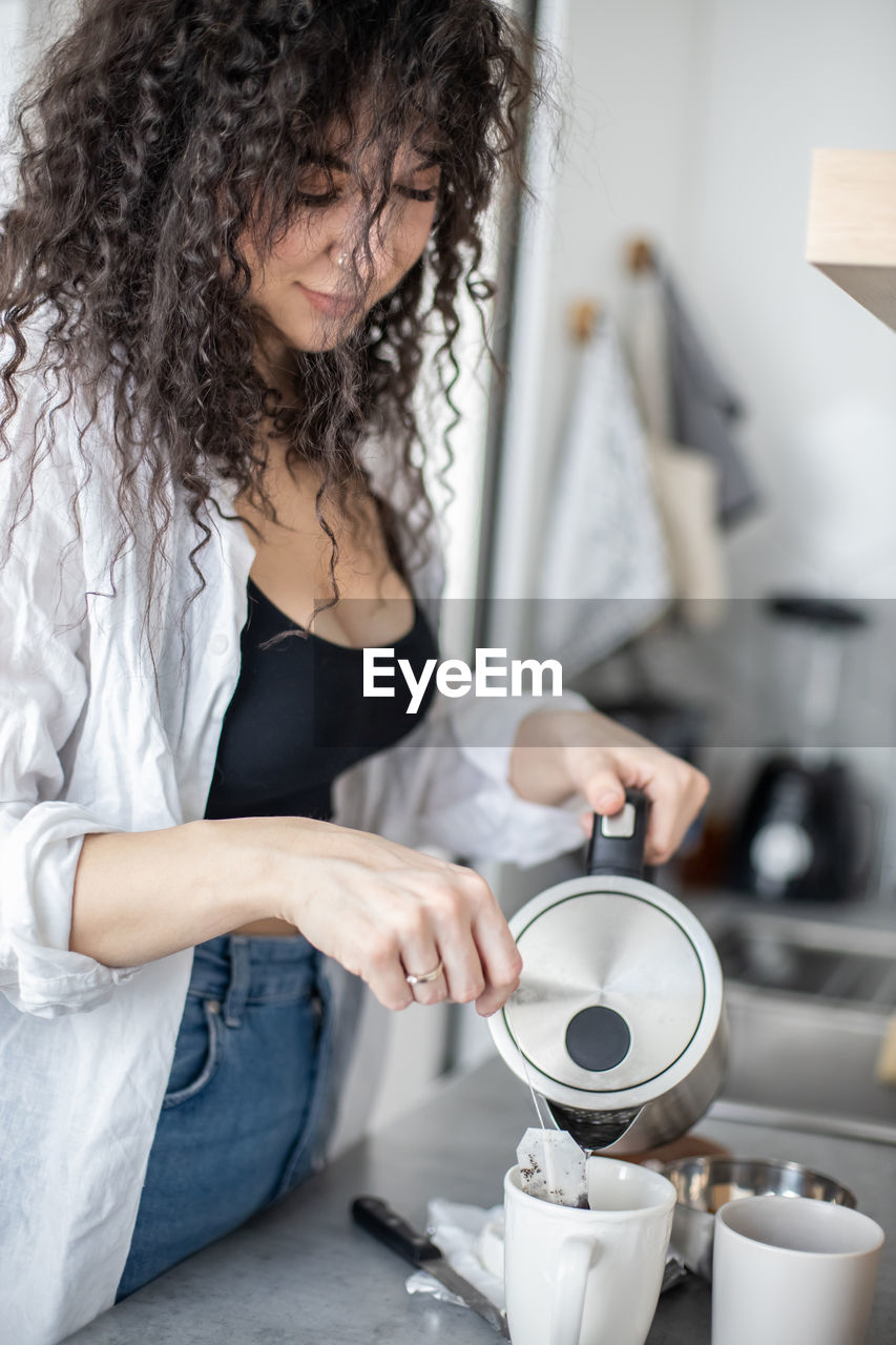 Woman preparing coffee at home