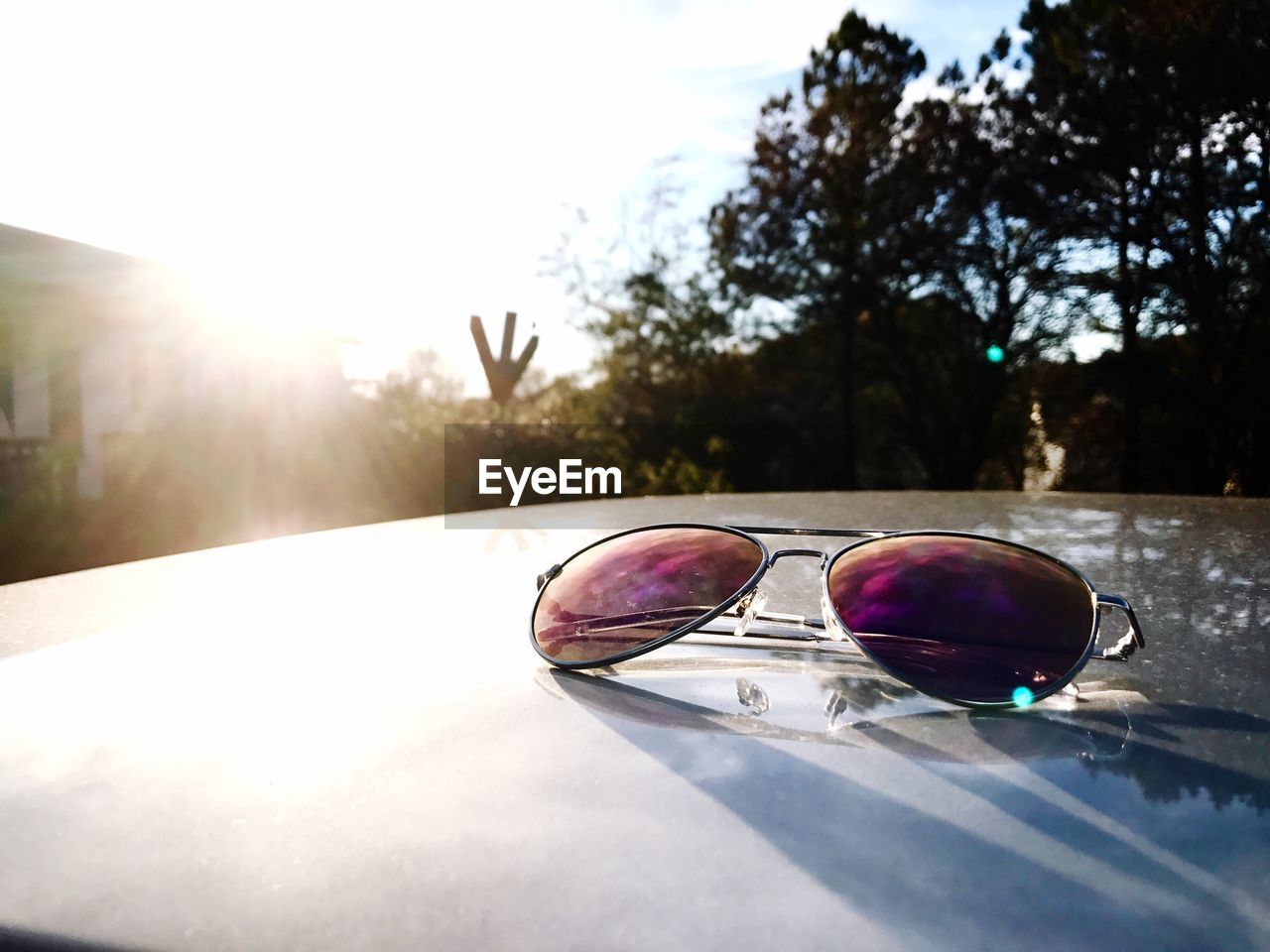 CLOSE-UP OF SUNGLASSES AND EYEGLASSES ON MIRROR