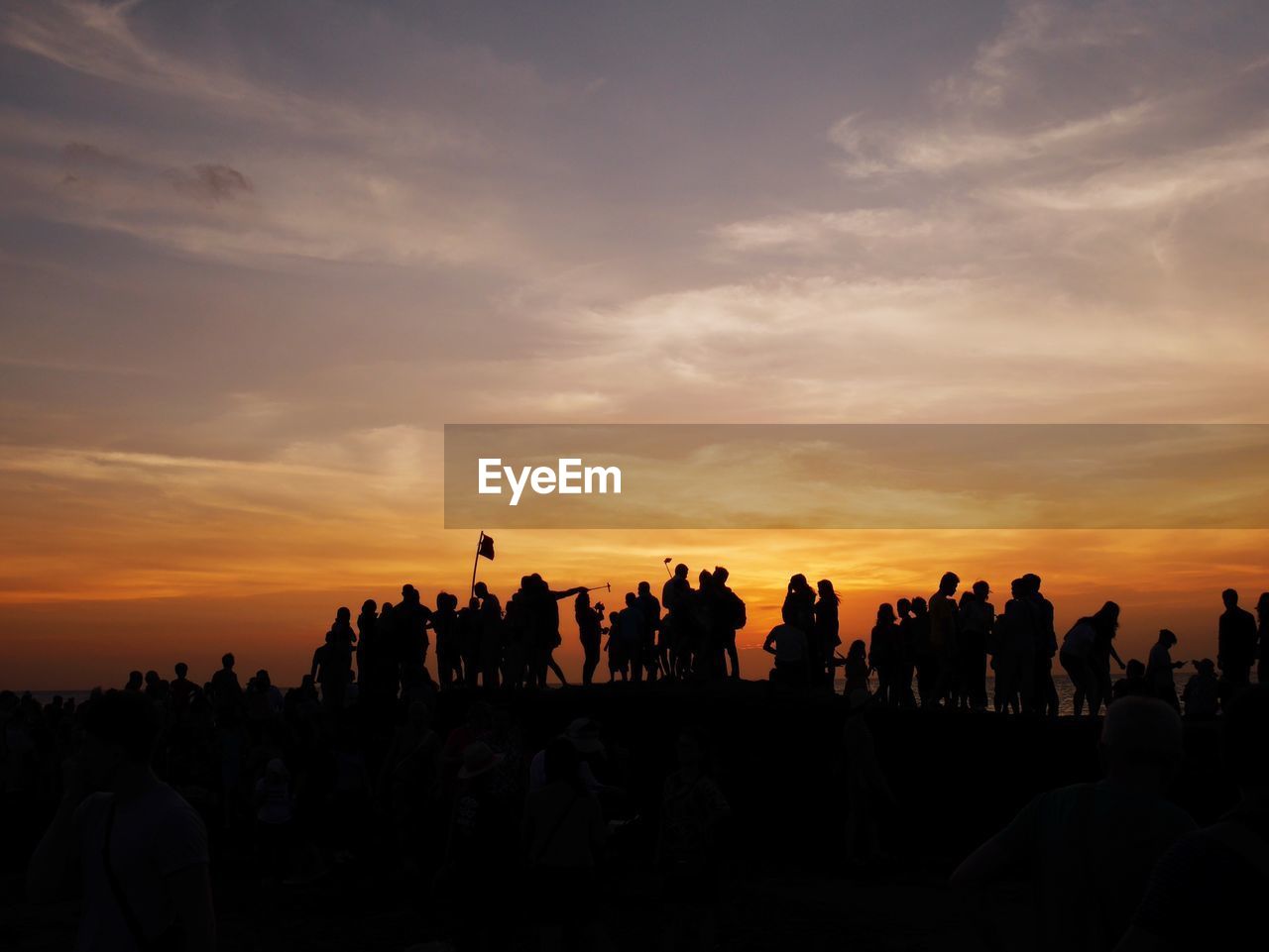 Silhouette people against sky during sunset