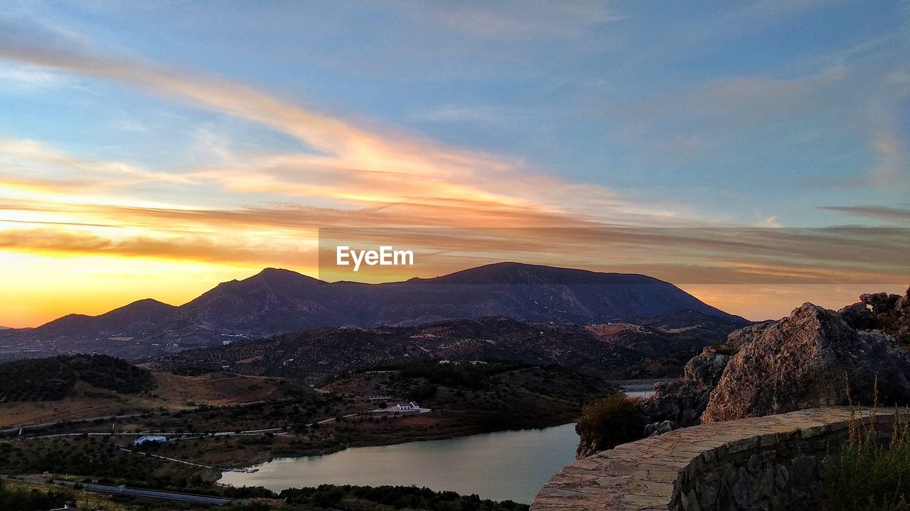 Scenic view of lake against sky during sunset