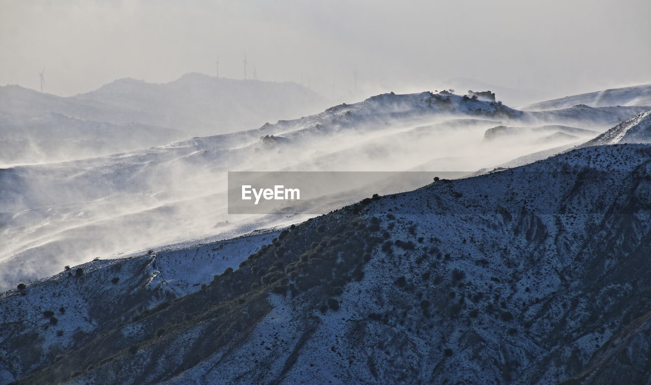 Scenic view of mountains against sky during winter